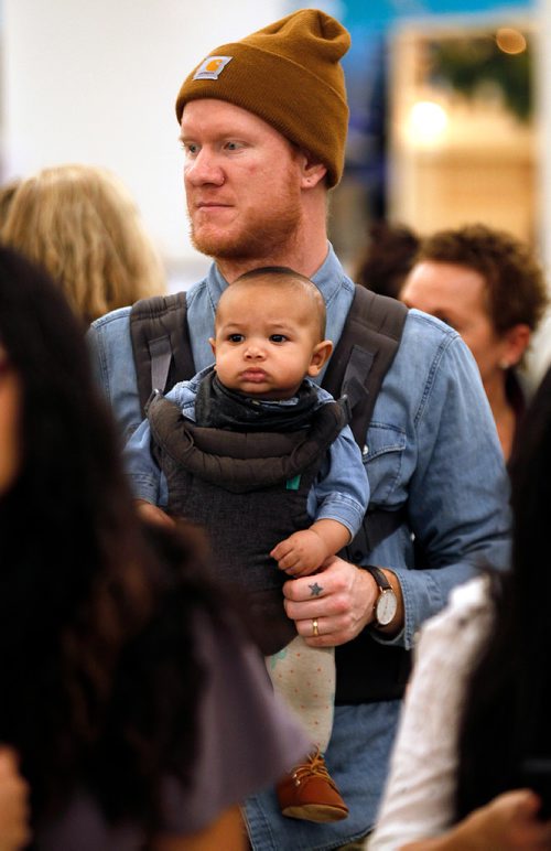 PHIL HOSSACK / WINNIPEG FREE PRESS - Brady Friesen and Charlie (4.5mo) manouvre through the opening night crowd at Third and Bird's annual Christmas Market Friday evening in The Bay's basement. - November 23, 2018