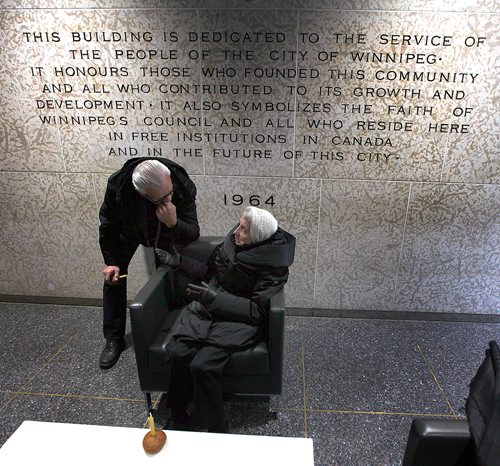 PHIL HOSSACK / WINNIPEG FREE PRESS - 83 yr old Zena Dlugosh speaks with her son Wolodymyr inside the foyer at City Hall as members of Winnipeg's Ukrainian Community gather Saturday to mark Ukrainian Famine and Genocide (Holodomor) Memorial Day. Born immediately after the famine family memories are still clear in Zena's mind. The inscription on the wall behimnd them is dedicated to all who came and reside here. Alex Paul story. - November 24, 2018