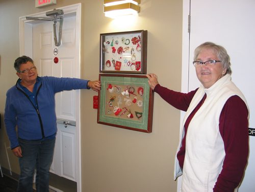 Canstar Community News Nov. 19, 2018 - (From left) Sandra Halstead, of Starbuck, and Sharon Ferrill, of Headingley, stand next to framed displays of the unique pin-ons created by the Starview Manor Ladies Auxiiary members. (ANDREA GERARY/CANSTAR COMMUNITY NEWS)