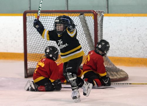 Brandon Sun 22032009 Calder Anderson #10 of the Bruins celebrates after scoring a goal during the Bruins Timbit Jamboree Hockey year-end windup match against the Flames at the Sportsplex on Sunday afternoon. (Tim Smith/Brandon Sun)