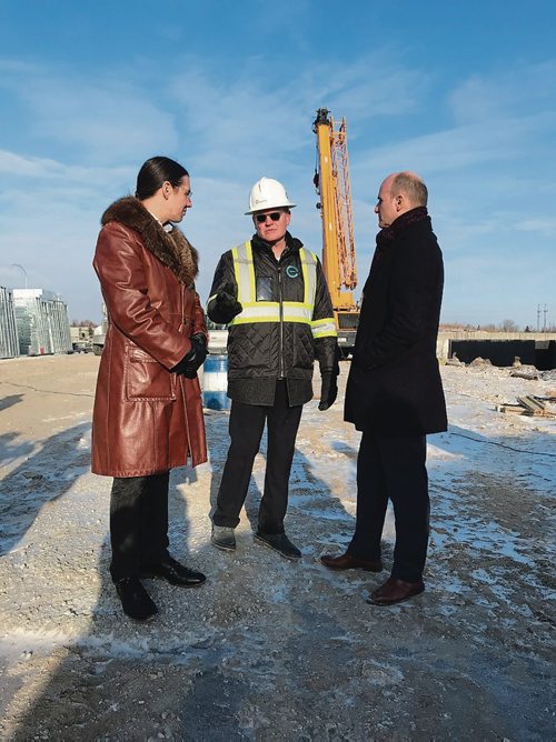 Canstar Community News Nov. 20, 2018 - EdgeCorp's Keith Merkel (centre) shows Winnipeg Centre MP Robert-Falcon Ouellette (left) and Jean-Yves Duclos, Minister of Children, Families and Social Development and minister responsible for Canada Mortgage and Housing Corporation, the site of a new 6-storey, 95 unit affordable housing development which received an $18 million loan through the CMHC's Rental Construction Financing Iniative. All units in the building, which is expected to be complete in October 2019, will have rents at or lower than the 30 per cent median household income for the area. (SHELDON BIRNIE/CANSTAR/THE HERALD)