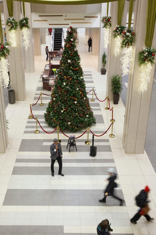 MIKE DEAL / WINNIPEG FREE PRESS
Chad Celaire, in front of the huge tree in Cityplace shopping centre, has for the last three holiday seasons rented out his vocal services, billing himself as The Christmas Singer.
181127 - Tuesday, November 27, 2018.