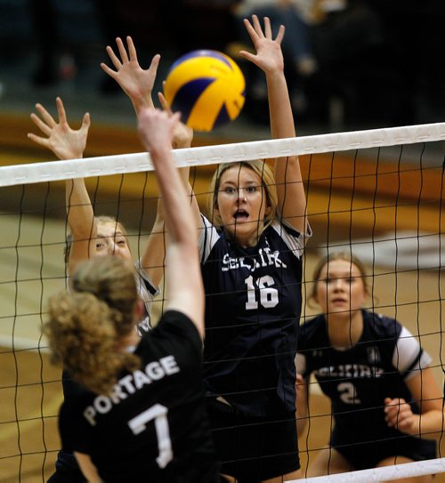 PHIL HOSSACK / WINNIPEG FREE PRESS -Selkirk Royal #16 (No name on Program) blocks the ball against Portage  Saint #7 Devon Borody.  - November 28, 2018