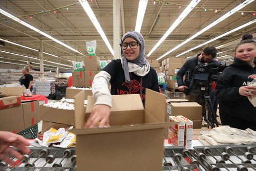 RUTH BONNEVILLE / WINNIPEG FREE PRESS

CHEER BOARD

Archwood School student Husnieh Apache packs food hampers with her fellow students Thursday. 

Students from Archwood School (Grades 7/8) pack food from Sobeys, Safeway and other sources for food hampers during the  Christmas Cheer Board Open House on Thursday.
Cheer board director. Kai Madsen, receives cheque for $15,000. from Sobeys coordinator, Natalina Porpiglia-Dafnis, at open house just prior to students packing hampers on Thursday.

 
Jen Zorrati story.


Nov 29th, 2018