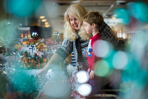 MIKAELA MACKENZIE / WINNIPEG FREE PRESS
Terry Vanoutrive shows Oscar McLaren, three, the Christmas village that she has built every year with her husband at their residence, Fred Douglas Place, in Winnipeg on Friday, Nov. 23, 2018.
Winnipeg Free Press 2018.