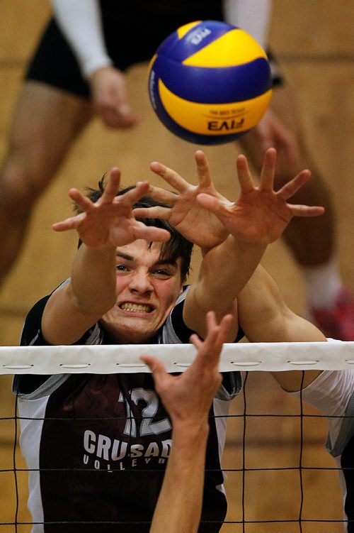 PHIL HOSSACK / WINNIPEG FREE PRESS - St Paul Crusader #12 Darian Koskie grimaces as he puts up a block against the Selkirk Roaylas in playoff action Thursday evening.  - November 29, 2018