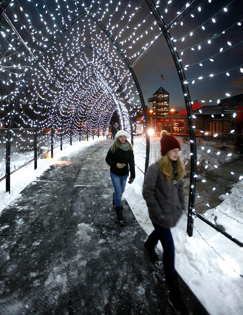 PHIL HOSSACK / WINNIPEG FREE PRESS - Winter Trekkers make their way through an archway in the 'Winter Garden at the Forks Friday night after the lights were officially lit to open the winter trails, walking trails for now soon to be skating trails.  See release.  - November 30, 2018