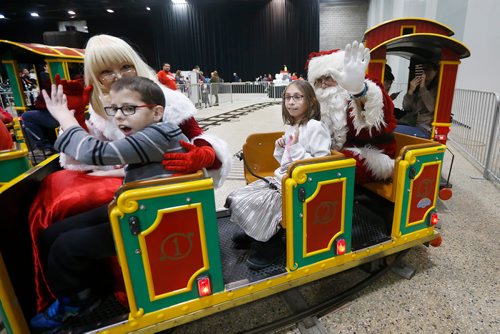 JOHN WOODS / WINNIPEG FREE PRESS
Kaitlynn Hinther, 10, rides a train with Santa  at the second annual Holiday Carnival at the Convention Centre Sunday, December 2, 2018.