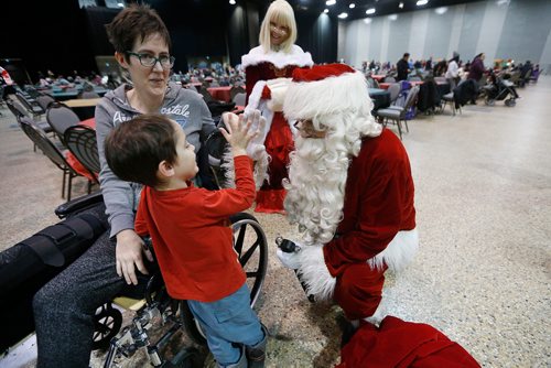 JOHN WOODS / WINNIPEG FREE PRESS
Cedric Crevier, 5.5, gives Santa a high-five as his mum Bridget and Mrs Claus look on at the second annual Holiday Carnival at the Convention Centre Sunday, December 2, 2018.
