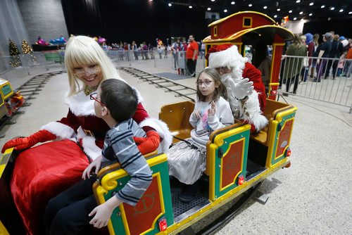 JOHN WOODS / WINNIPEG FREE PRESS
Kaitlynn Hinther, 10, rides a train with Santa  at the second annual Holiday Carnival at the Convention Centre Sunday, December 2, 2018.