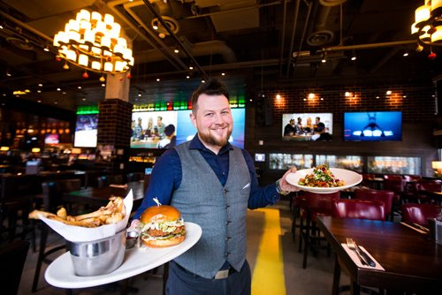 MIKAELA MACKENZIE / WINNIPEG FREE PRESS
Justin Guest, manager, poses with the Nashville Chicken Sandwich and the Dragon Bowl at Brown's Social House downtown location on Monday, Dec. 3, 2018.
Winnipeg Free Press 2018.