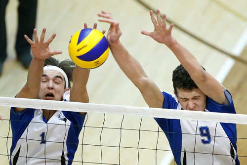 JOHN WOODS / WINNIPEG FREE PRESS
 Lord Selkirk Royals' Carl LeBlanc (1) and Nick Brzoza (9) defend against Dakota Lancers in the Manitoba High School Volleyball final at the University of Manitoba Monday, December 3, 2018.