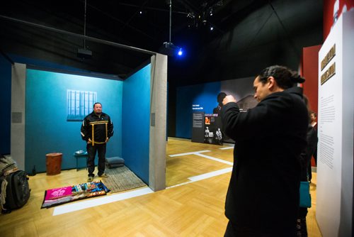 MIKAELA MACKENZIE / WINNIPEG FREE PRESS
Provincial NDP leader Wab Kinew takes a photo of Indigenous leader Derek Nepinak as he spends 27 hours fasting in an eight-foot by seven-foot replica of Nelson Mandela's jail cell as a personal journey to reflect on the parallels between the apartheid system and the experience of Indigenous people in Canada in Winnipeg on Tuesday, Dec. 4, 2018.
Winnipeg Free Press 2018.