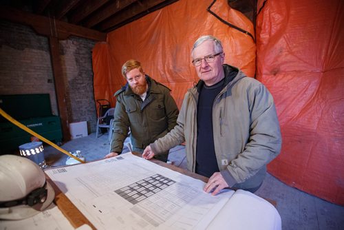 MIKE DEAL / WINNIPEG FREE PRESS
Alex Boersma (left) co-developer of the project from Legatum Developments and Site Manager, Henry Wiebe (right), go over the blueprints.
Warehouse 1885, a repurposing of a historic building built in 1885 to a 39-unit residential complex at 104 Princess Street.
181204 - Tuesday, December 04, 2018.