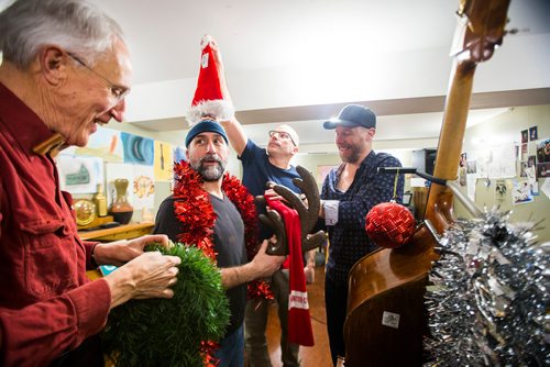 MIKAELA MACKENZIE / WINNIPEG FREE PRESS
Al Simmons (left), Gilles Fournier, Daniel Roy, and Murray Pulver try decorating Al and the bass while rehearsing for a concert series at the West End Cultural Centre in Winnipeg on Wednesday, Dec. 5, 2018.
Winnipeg Free Press 2018.