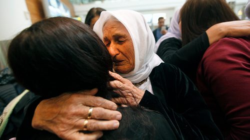 PHIL HOSSACK / WINNIPEG FREE PRESS - Overwhelmed by travel and welcome, Family matriarch Shireen Khudida embraces the throngs of Yazidi's who came to Richardson International Airport Thursday to welcome the matriarch and the last of "Operation Ezra's" Yazidi families to Winnipeg and Canada. See Carol Sanders story. - March 29, 2018