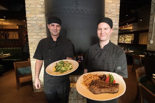 Mike Sudoma / Winnipeg Free Press
Chefs (right) Paul Blawat, and (left) Scott Andrus show off some freshly prepared meals at The Keg downtown on Garry St Wednesday afternoon
December 5, 2018