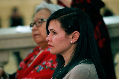 PHIL HOSSACK / WINNIPEG FREE PRESS -Emily Cablek listens as approximately 100 people gathered at the legislature's rotunda  Thursday evening to mark the National Day of Remembrance and Action on Violence Against Women. Emily survived an abusive relationship, only to have her children kidnapped by her ex. They were returned years later from Mexico. - December 6, 2018