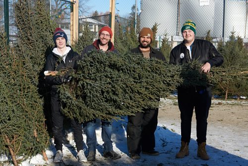 DAVID LIPNOWSKI / WINNIPEG FREE PRESS

(Left to right) Miles Macdonell Collegiate Buckeyes Receiver Miciah Stone, Y Service Club members Sean Strachan, and Michael Wahl, and Miles Macdonell Collegiate Buckeyes Offensive Lineman Matthew Stow pose for a portrait with a Christmas tree at the non-profit volunteer operated Tree Lot at 454 Kimberly Avenue beside Miles Macdonell Collegiate Saturday December 8, 2018.