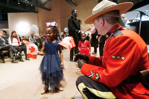 JOHN WOODS / WINNIPEG FREE PRESS
Christine Bazie receives a flag from a RCMP officer during a Canadian citizenship ceremony at the Canadian Museum for Human Rights as part of the celebration of the 70th anniversary of the United Nations' Universal Declaration of Human Rights Sunday, December 9, 2018.