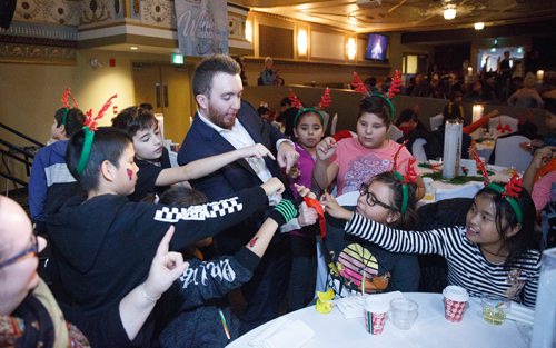 MIKE DEAL / WINNIPEG FREE PRESS
Magician Evan Morgan entertains a table of kids during the Variety Manitoba Winter Wonderland party. Around 300 underprivileged inner city kids were invited to Variety Manitoba's Winter Wonderland childrens party at The Metropoitan Entertainment Centre Monday, December 10. They were served lunch, got to listen to live Christmas music, entertained by magician's, and met Santa and Mrs. Claus. 

181210 - Monday, December 10, 2018.