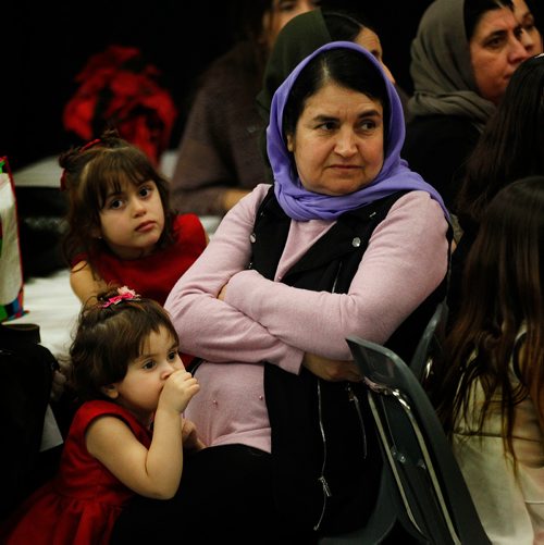 PHIL HOSSACK / WINNIPEG FREE PRESS - Naam Zaghil sits patiently with her daughters Radya 5, (top) and Soma 2 during theopening speeches at the traditional Feast of Ezi (the Almighty) Friday night as the Yazidi community gathered to break a three day fast marking the evnt all Yazidis are expected to observe. Many of the Yazidi community gathered at the Dakota Community centre for the feast came to Canada after escaping imprisonment torture and rape at the hands of ISIS.
A special event was to happen after the feast when 100+ bicycles donated by an anonymous donor were to be handed out to newly arrived children. - December 13, 2018