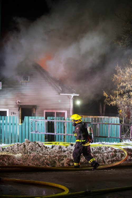 MIKAELA MACKENZIE / WINNIPEG FREE PRESS
Firefighters work to put out a house fire On Stella Ave between Parr and MacKenzie streets around midnight in Winnipeg on Saturday, Dec. 15, 2018. 
Winnipeg Free Press 2018.