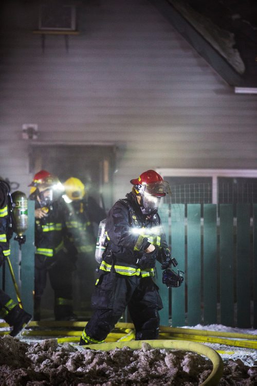 MIKAELA MACKENZIE / WINNIPEG FREE PRESS
Firefighters work to put out a house fire On Stella Ave between Parr and McKenzie streets around midnight in Winnipeg on Saturday, Dec. 14, 2018. 
Winnipeg Free Press 2018.