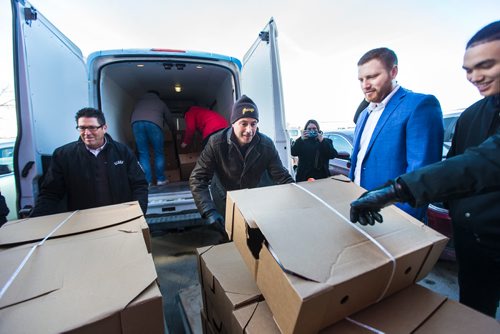 MIKAELA MACKENZIE / WINNIPEG FREE PRESS
Crown Auto Group and Granny's representatives haul in $30,000 worth of turkeys to the Christmas Cheer Board in Winnipeg on Monday, Dec. 17, 2018. 
Winnipeg Free Press 2018.