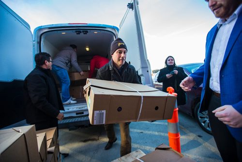 MIKAELA MACKENZIE / WINNIPEG FREE PRESS
Granny's director of marketing Jason Wortzman (centre) hauls in $30,000 worth of turkeys with other Crown Auto Group and Granny's representatives to the Christmas Cheer Board in Winnipeg on Monday, Dec. 17, 2018. 
Winnipeg Free Press 2018.