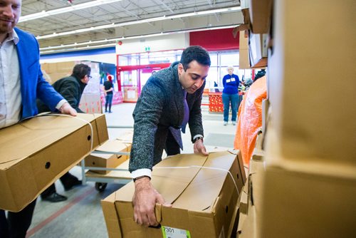 MIKAELA MACKENZIE / WINNIPEG FREE PRESS
Kabeir Dilawri, VP of sales with Crown Auto Group (centre), helps unload $30,000 worth of turkeys to the Christmas Cheer Board in Winnipeg on Monday, Dec. 17, 2018. 
Winnipeg Free Press 2018.