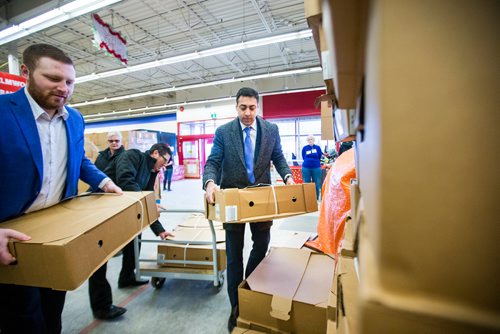 MIKAELA MACKENZIE / WINNIPEG FREE PRESS
Kabeir Dilawri, VP of sales with Crown Auto Group (centre), helps unload $30,000 worth of turkeys to the Christmas Cheer Board in Winnipeg on Monday, Dec. 17, 2018. 
Winnipeg Free Press 2018.