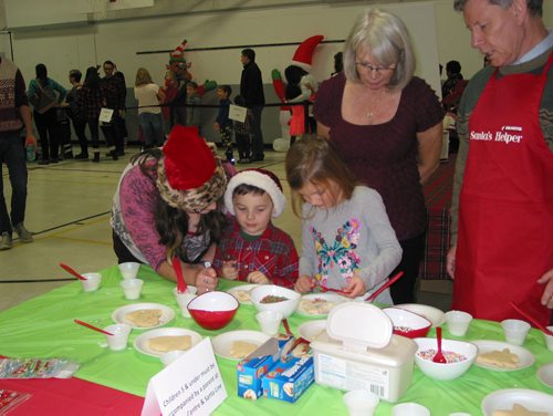 Canstar Community News Dec. 8, 2018 - Youngsters attending the Dakota Community Centre's Santa Breakfast on Dec. 8 were able to decorate sugar cookies. Winnipeg South MLA Terry Duguid (at right) was one of the volunteers helping out. (ANDREA GEARY/CANSTAR COMMUNITY NEWS)
