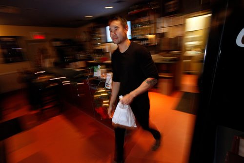 PHIL HOSSACK / WINNIPEG FREE PRESS -  Anou Konmanisvong hustles a take out order at Siam Thai Friday afternoon. December 21, 2018.