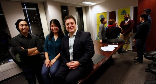 PHIL HOSSACK / WINNIPEG FREE PRESS - John Prystanski (right) poses with Duyen Chau and Jessie Asuncion (left) at a Westland Foundation meeting Friday night. Other alumnists chat in the background. December 21, 2018.