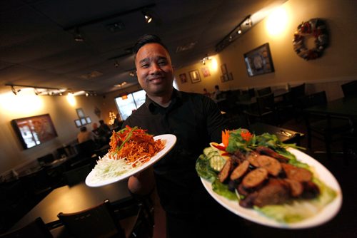PHIL HOSSACK / WINNIPEG FREE PRESS -  Mick Konmanisvong shows off a couple of the restaurant's feature dishes at Siam Thai Friday afternoon. December 21, 2018.