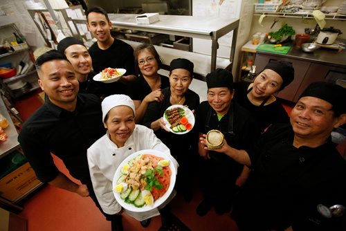 PHIL HOSSACK / WINNIPEG FREE PRESS -  Mick Konmanisvong and his other Sumruoy Poomrat (lowerleft) pose in the kitchen with staff at Siam Thai Friday afternoon. December 21, 2018.