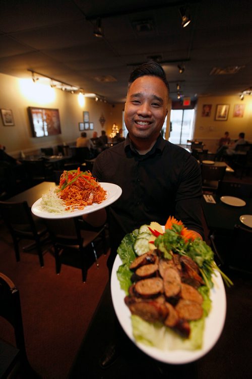 PHIL HOSSACK / WINNIPEG FREE PRESS -  Mick Konmanisvong shows off a couple of the restaurant's feature dishes at Siam Thai Friday afternoon. December 21, 2018.