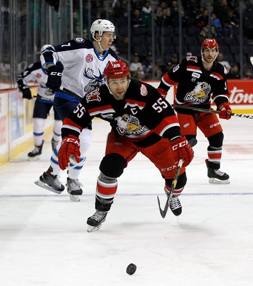 PHIL HOSSACK / WINNIPEG FREE PRESS - Grand Rapids Griffins' #55Matthew Ford chases the loose puck into the Moose zone as Manitoba Moose #7 Logan Stanley heads for the bench Friday.  December 21, 2018.