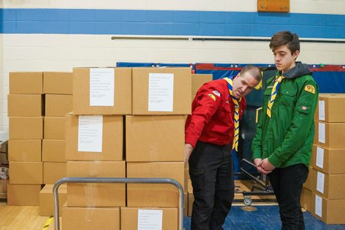 Katie McKenzie / Ma Mawi Wi Chi Itata Centre
William Moore (left) with the 1st River Park South Scouts and a scout member organize hampers at R. B. Russell School for the 16th annual Christmas Hamper Drive hosted by Ma Mawi Wi Chi Itata Centre and Bell MTS.

181222 - Saturday, December 22, 2018.