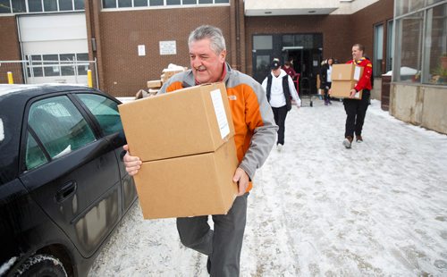 MIKE DEAL / WINNIPEG FREE PRESS
Angus MacKinnon carries boxes of hampers to his car for delivery at R. B. Russell School for the 16th annual Christmas Hamper Drive hosted by Ma Mawi Wi Chi Itata Centre and Bell MTS.
181222 - Saturday, December 22, 2018.