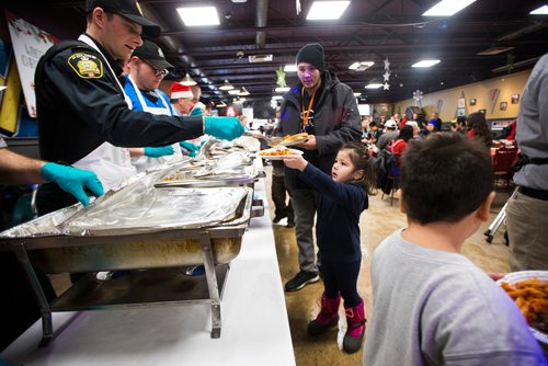 MIKAELA MACKENZIE / WINNIPEG FREE PRESS
Aubrey Thomas, four, is served at the 13th Annual Christmas Eve Feast for new immigrants, international students who cant make it home for the holidays, and people in the inner city at X-Cues Café in Winnipeg on Monday, Dec. 24, 2018. 
Winnipeg Free Press 2018.