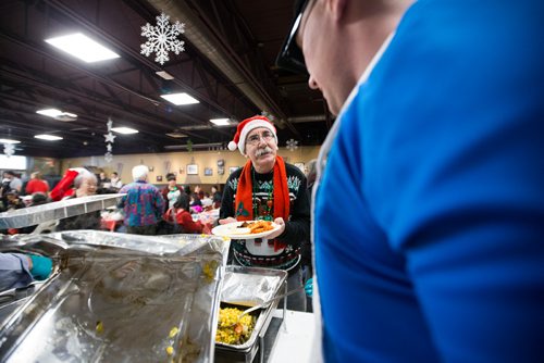 MIKAELA MACKENZIE / WINNIPEG FREE PRESS
Barry Kopulos is served at the 13th Annual Christmas Eve Feast for new immigrants, international students who cant make it home for the holidays, and people in the inner city at X-Cues Café in Winnipeg on Monday, Dec. 24, 2018. 
Winnipeg Free Press 2018.