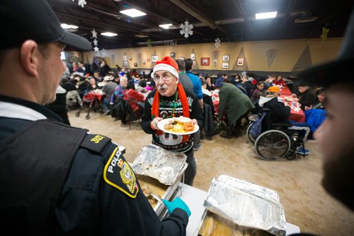 MIKAELA MACKENZIE / WINNIPEG FREE PRESS
Barry Kopulos is served at the 13th Annual Christmas Eve Feast for new immigrants, international students who cant make it home for the holidays, and people in the inner city at X-Cues Café in Winnipeg on Monday, Dec. 24, 2018. 
Winnipeg Free Press 2018.