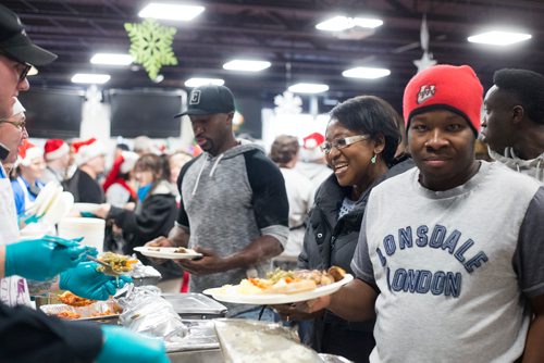 MIKAELA MACKENZIE / WINNIPEG FREE PRESS
Maggie Yeboah is served at the 13th Annual Christmas Eve Feast for new immigrants, international students who cant make it home for the holidays, and people in the inner city at X-Cues Café in Winnipeg on Monday, Dec. 24, 2018. 
Winnipeg Free Press 2018.