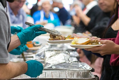 MIKAELA MACKENZIE / WINNIPEG FREE PRESS
The 13th Annual Christmas Eve Feast for new immigrants, international students who cant make it home for the holidays, and people in the inner city at X-Cues Café in Winnipeg on Monday, Dec. 24, 2018. 
Winnipeg Free Press 2018.