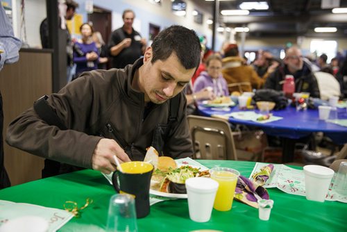 MIKE DEAL / WINNIPEG FREE PRESS
The Siloam Mission Christmas Eve meal serves over 600 people with anywhere from 65-100 volunteers to help make it happen on Monday December 24, 2018.
Raymond Caribou digs into his turkey dinner.
181224 - Monday, December 24, 2018.