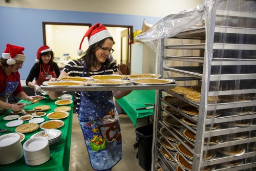 MIKE DEAL / WINNIPEG FREE PRESS
The Siloam Mission Christmas Eve meal serves over 600 people with anywhere from 65-100 volunteers to help make it happen on Monday December 24, 2018.
Volunteer Candice Semeniuk with a tray full of pumpkin pies just before service begins at noon.
181224 - Monday, December 24, 2018.