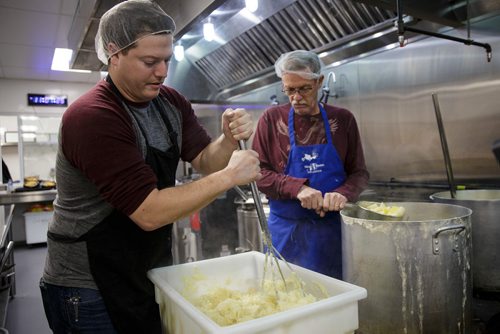 MIKE DEAL / WINNIPEG FREE PRESS
The Siloam Mission Christmas Eve meal serves over 600 people with anywhere from 65-100 volunteers to help make it happen on Monday December 24, 2018.
Volunteers Jeff Penniston (left) and his father Don (right) prepare the mashed potatoes just before service starts at noon.
181224 - Monday, December 24, 2018.