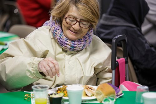 MIKE DEAL / WINNIPEG FREE PRESS
The Siloam Mission Christmas Eve meal serves over 600 people with anywhere from 65-100 volunteers to help make it happen on Monday December 24, 2018.
Carroll Caron digs into her turkey dinner.
181224 - Monday, December 24, 2018.